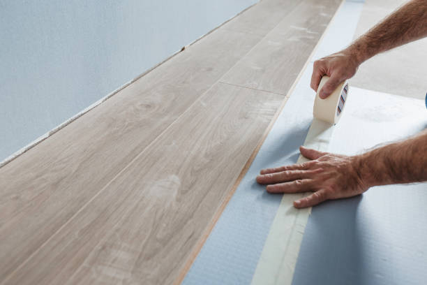 istock Floating flooring foreman glues foam backing sheets with tape 1368920949