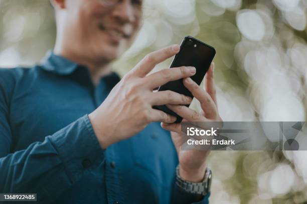 Sales Manager Checking Order In His Mobile Phone Stock Photo - Download Image Now - Business, Working, Discussion