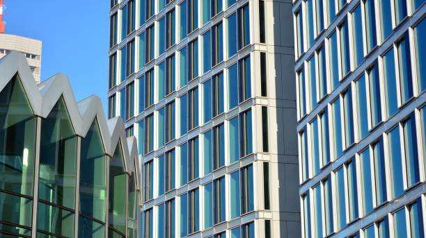 istock Commercial building close up in blue tone. Gigantic skyscraper from below. 1368923576