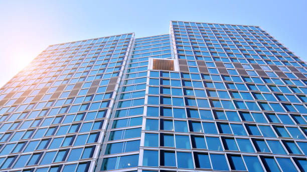 istock Commercial building close up in blue tone. Gigantic skyscraper from below. 1368923828