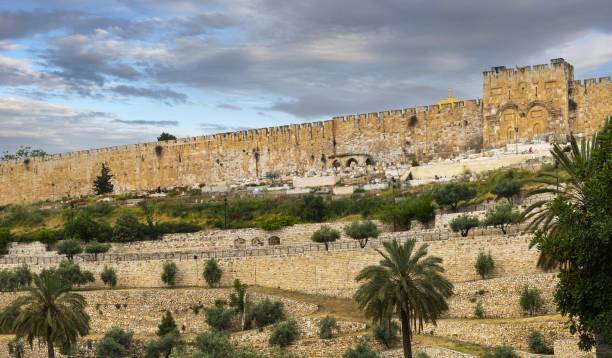 Wall of the Jerusalem Old City and Golden Gate East Jerusalem, Palestine, May 2, 2019: View of the wall of the Jerusalem Old City. On the right is the Golden Gate and a part of the golden cupola of the Dome of the Rock. kidron valley stock pictures, royalty-free photos & images