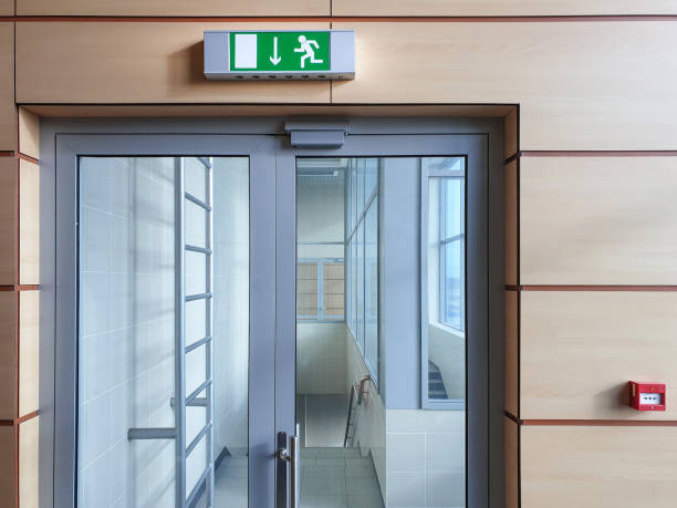 Emergency exit with glass door in airport office building. Emergency fire doors. Emergency exit with glass door in airport office building. Emergency fire doors. Rescue signs icon green emergency exit lamp exit sign photos stock pictures, royalty-free photos & images
