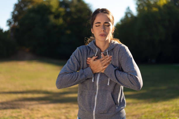 Young sporty woman has chest pain stock photo