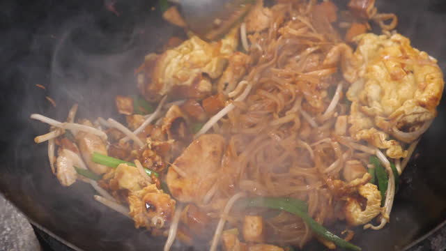 close up of moving wok with a Pad Thai