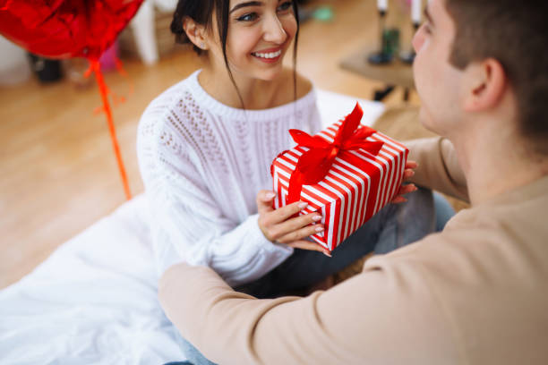 istock Valentine's Day concept. Lovers give each other gifts. 1368929619