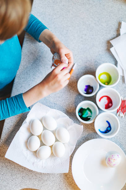 istock Mother and son painting eggs for Easter 1368931080