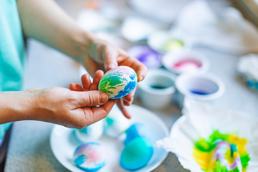 Mother and son painting eggs for Easter