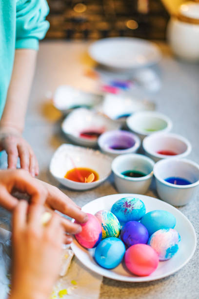 istock Mother and son painting eggs for Easter 1368931159