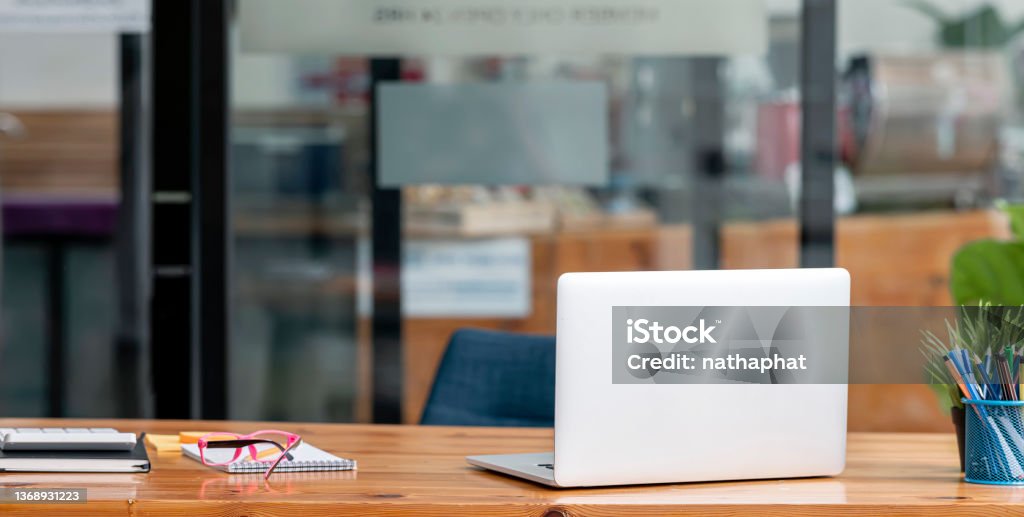 Laptop mock up, decor and copy space on minimal wooden working desk. Laptop Stock Photo