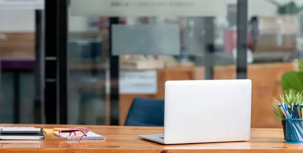 Photo of Laptop mock up, decor and copy space on minimal wooden working desk.