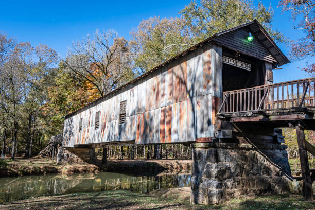 Childersburg, Alabama, USA - Nov. 14, 2021: Historic Kymulga Covered Bridge on Talladega Creek built in the 1861 is one of only 2 historic covered bridges in their original location in Alabama.