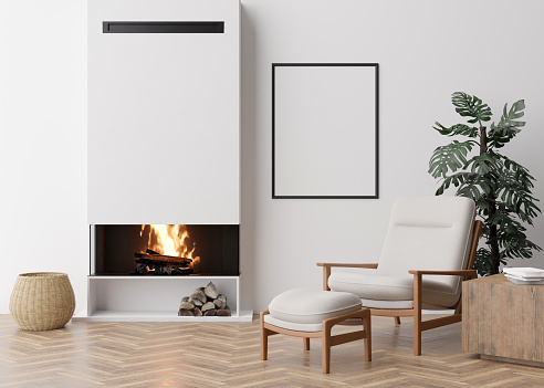 Empty vertical picture frame on white wall in modern living room. Mock up interior in contemporary style. Free space for picture, poster. Armchair, fireplace, monstera plant. 3D rendering.