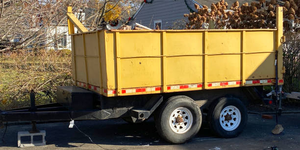 istock Yellow dumpster on a trailer in a driveway 1368935099