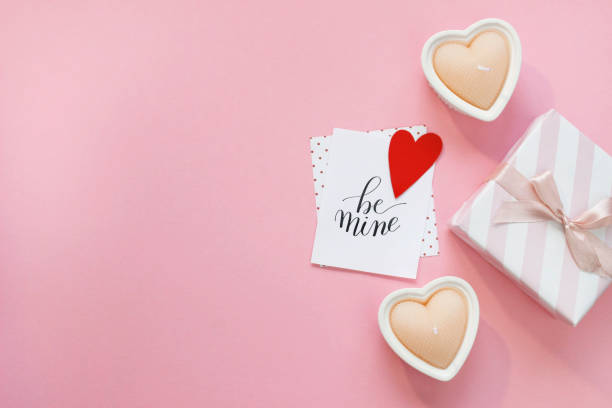 istock Happy Valentines Day composition. Blank greeting card mockup, gift boxes, red hearts, confetti on pink background 1368935183