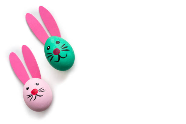 two Easter Eggs hand painted with bunny face and ears isolated on white background