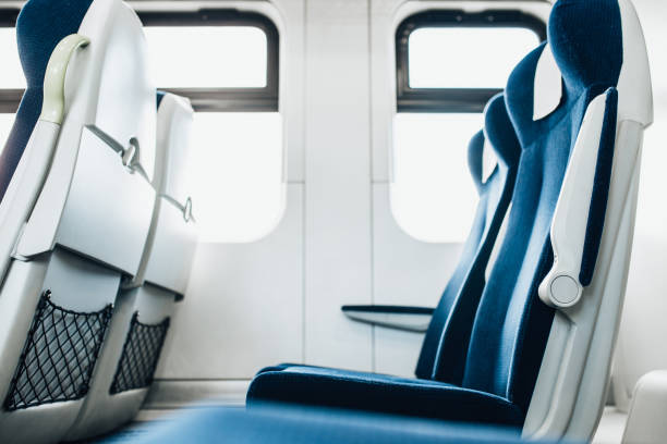 Rows of seated soft comfortable chairs in carriage Rows of seated soft comfortable chairs in a high-speed train carriage train interior stock pictures, royalty-free photos & images