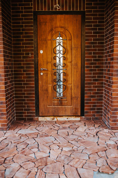 istock Beautiful vintage style wooden door with wrought iron decorative elements 1368935281