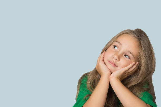 istock Child little girl with a pensive expression on her face. 1368936229