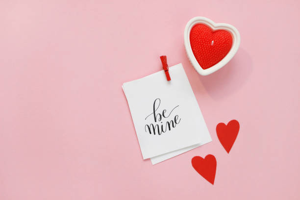 istock Happy Valentines Day composition. Blank greeting card mockup, red hearts, confetti on pink background 1368937373
