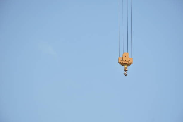 istock yellow hook of heavy crane for construction building hanging in  sky background 1368939949