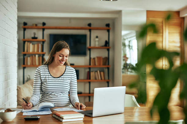 istock Woman using a laptop while working on her home finances 1368940388
