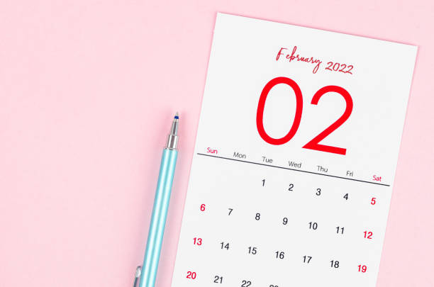 istock February 2022 calendar with pen on pink background. 1368941064