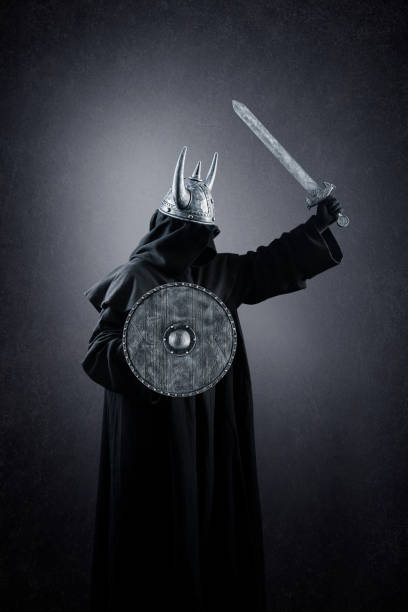istock Warrior with horned helmet, round shield and sword in the dark 1368942739
