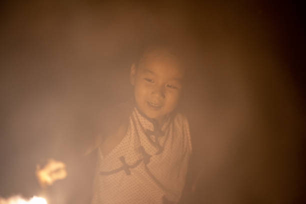 Asian children playing fireworks during celebration