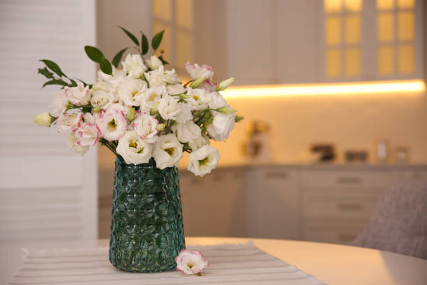istock Bouquet of beautiful flowers on table in kitchen, space for text. Interior design 1368945774