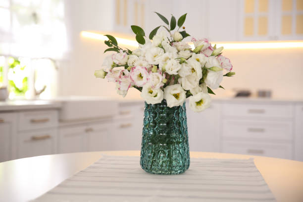 istock Bouquet of beautiful flowers on table in kitchen. Interior design 1368945993