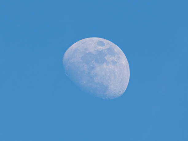 istock Moon on blue sky of daytime background 1368948569