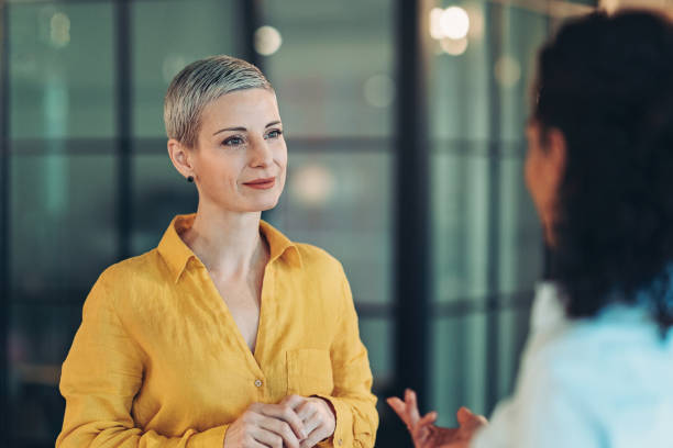 Businesswoman Two businesswomen talking in the office face to face stock pictures, royalty-free photos & images