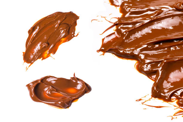 istock Melted tasty caramel splashes isolated on white background. 1368948809