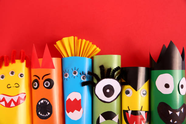 istock Funny monsters on red background, flat lay. Halloween decoration 1368948906