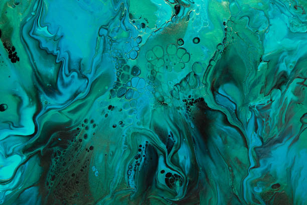 istock Fluid Art. Green and blue abstract wave swirls on black background. Marble effect background or texture 1368948982