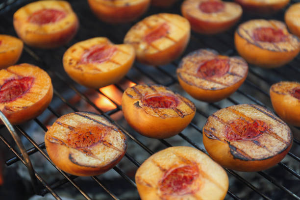 istock Modern grill with tasty cut peaches, closeup 1368949033