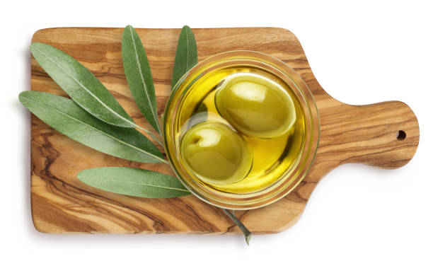 istock Delicious olives on wooden board, view from above, on white 1368949888