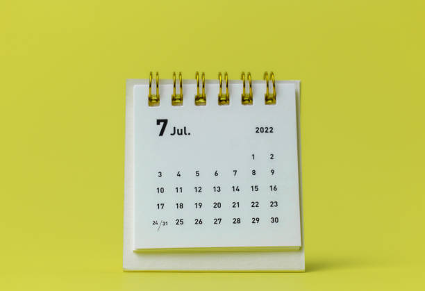 istock Desktop calendar for July 2022 on a yellow background. 1368951896