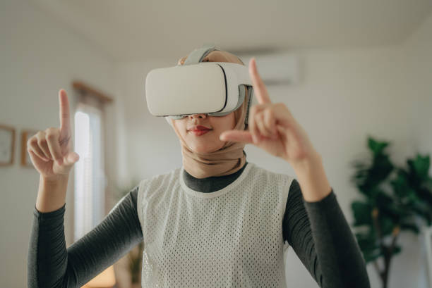 istock Young woman with VR headset exploring virtual reality 1368953688