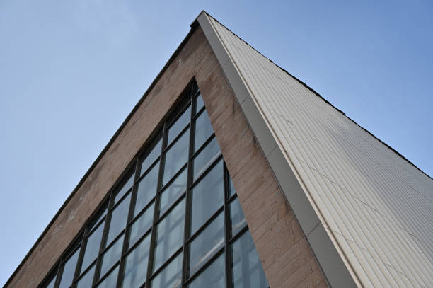 istock Geometric composition of glass and concrete against a blue cloud 1368954939