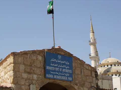 Madaba, Jordan, August 9, 2010: Mosque and minaret in front of the Antiquities Department of the Archeology Park in Madaba, Jordan