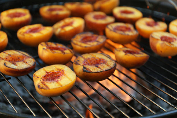 istock Modern grill with tasty cut peaches, closeup 1368955248