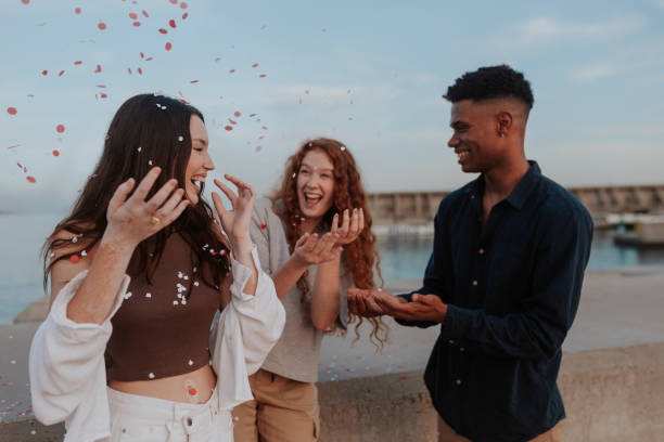 istock Throwing confetti party by the sea 1368959196