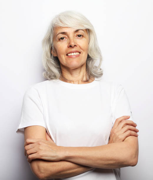 istock Smiling Elderly Woman With Crossed Hands 1368961236
