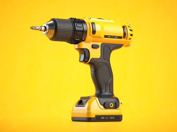 istock Yellow electric screwdriver drill  on yellow background 1368963359