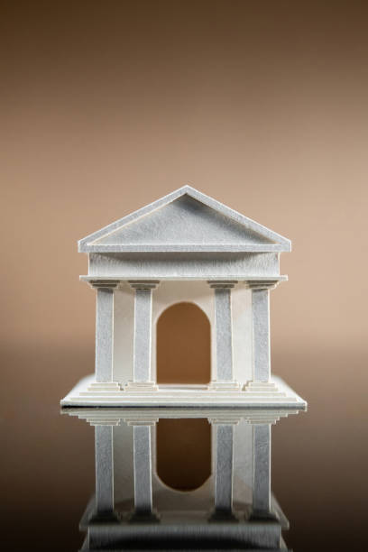 istock Banking concept. Paper bank building model reflected on table. 1368964276