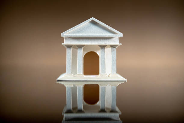 istock Banking concept. Paper bank building model reflected on table. 1368964493