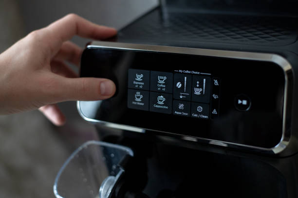 istock A man's hand presses the power button of a black coffee machine 1368965839