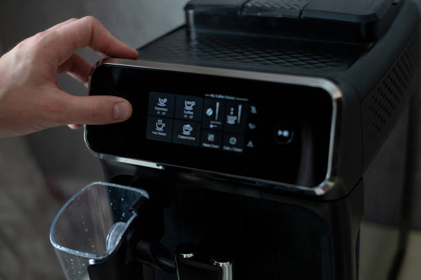 istock A man's hand presses the power button of a black coffee machine 1368965851