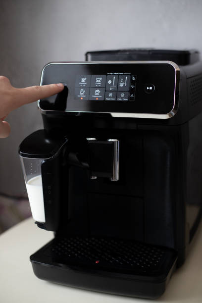 istock A man's hand presses the power button of a black coffee machine 1368965869